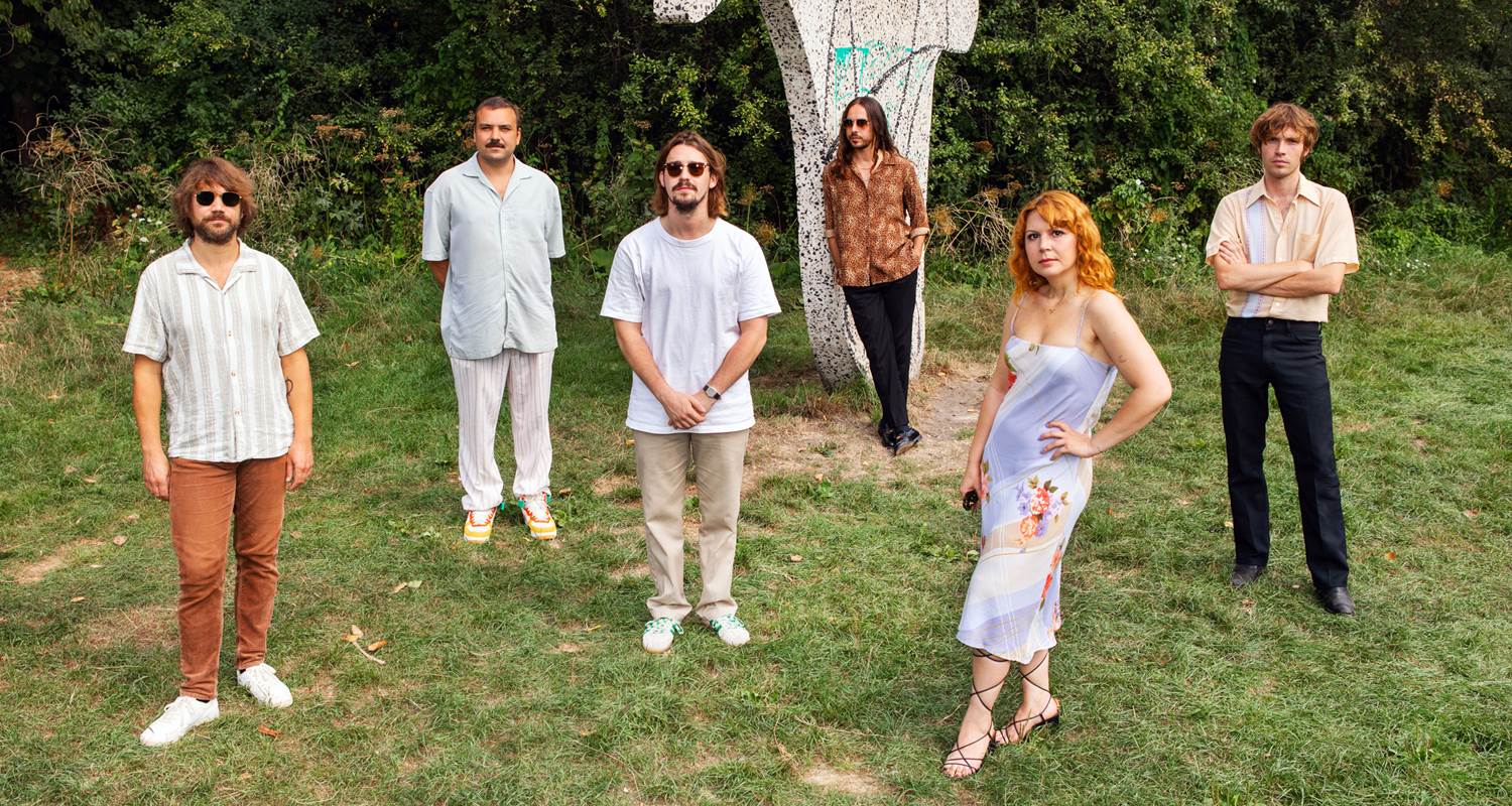 A group of people posing in front of a tree at a Copenhagen event.
