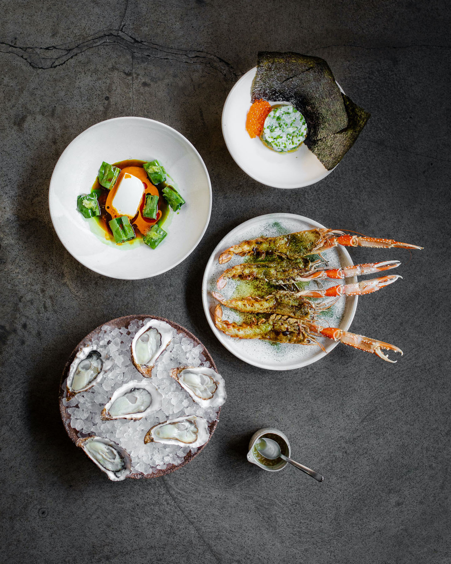 A group of plates with seafood and ice on them served at Copenhagen restaurants.