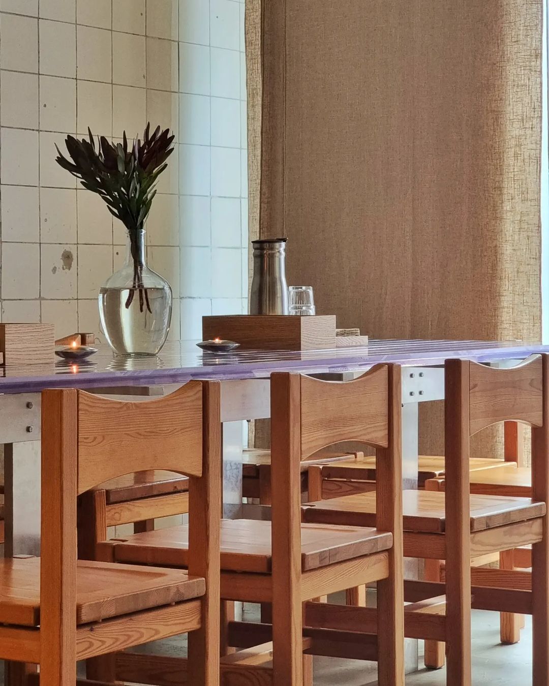A Copenhagen restaurant featuring a wooden dining table and chairs.