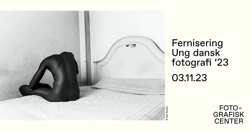 A black and white photo of a woman on a bed.