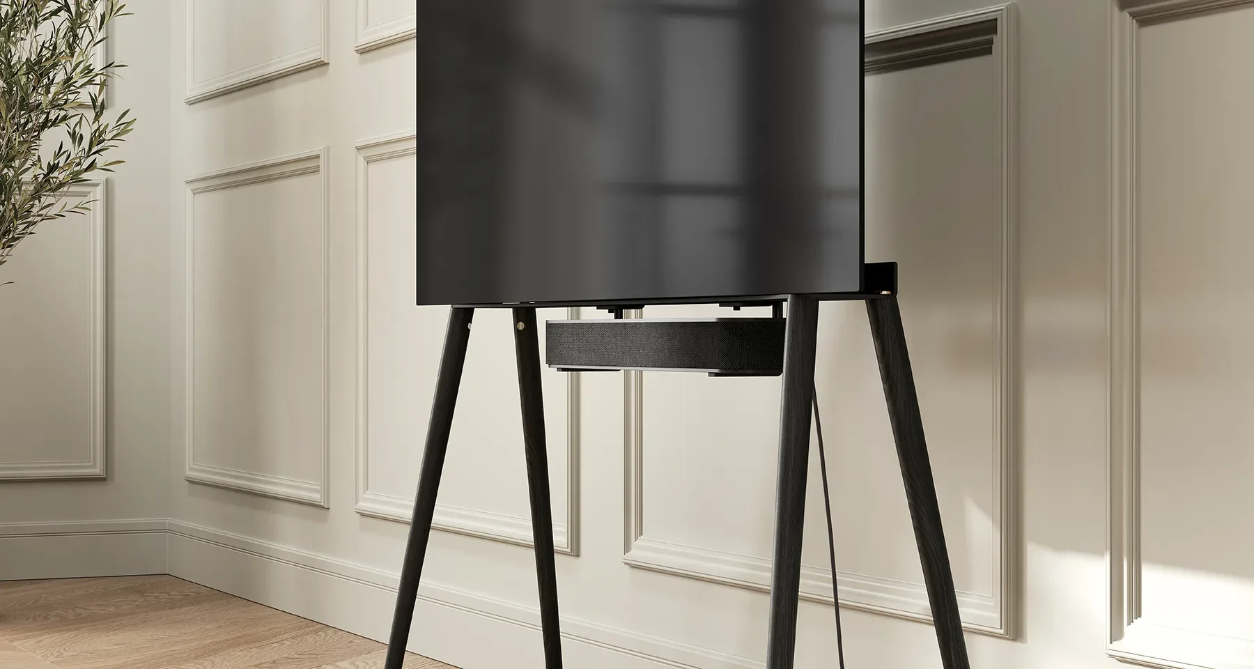 A minimalist TV stand supporting a sleek black TV in a room.