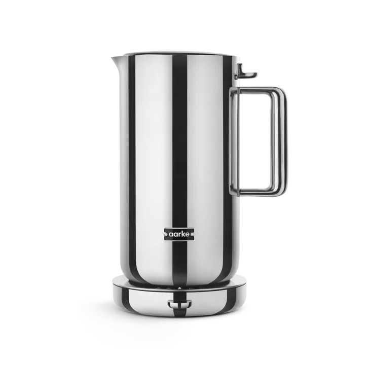 A stainless steel electric kettle with a sleek, modern design sits on a circular base.