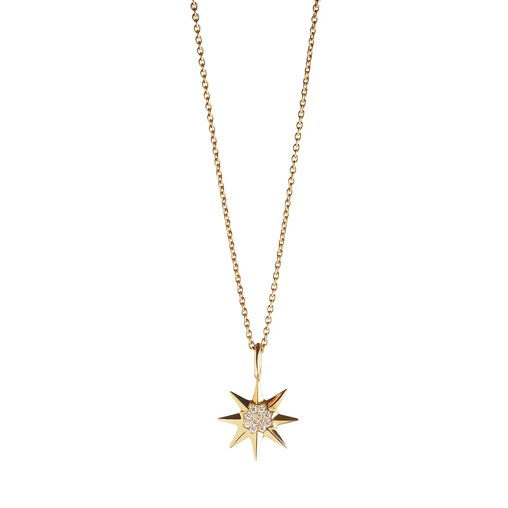 Gold chain necklace with an eight-pointed star pendant featuring small diamonds at the center.