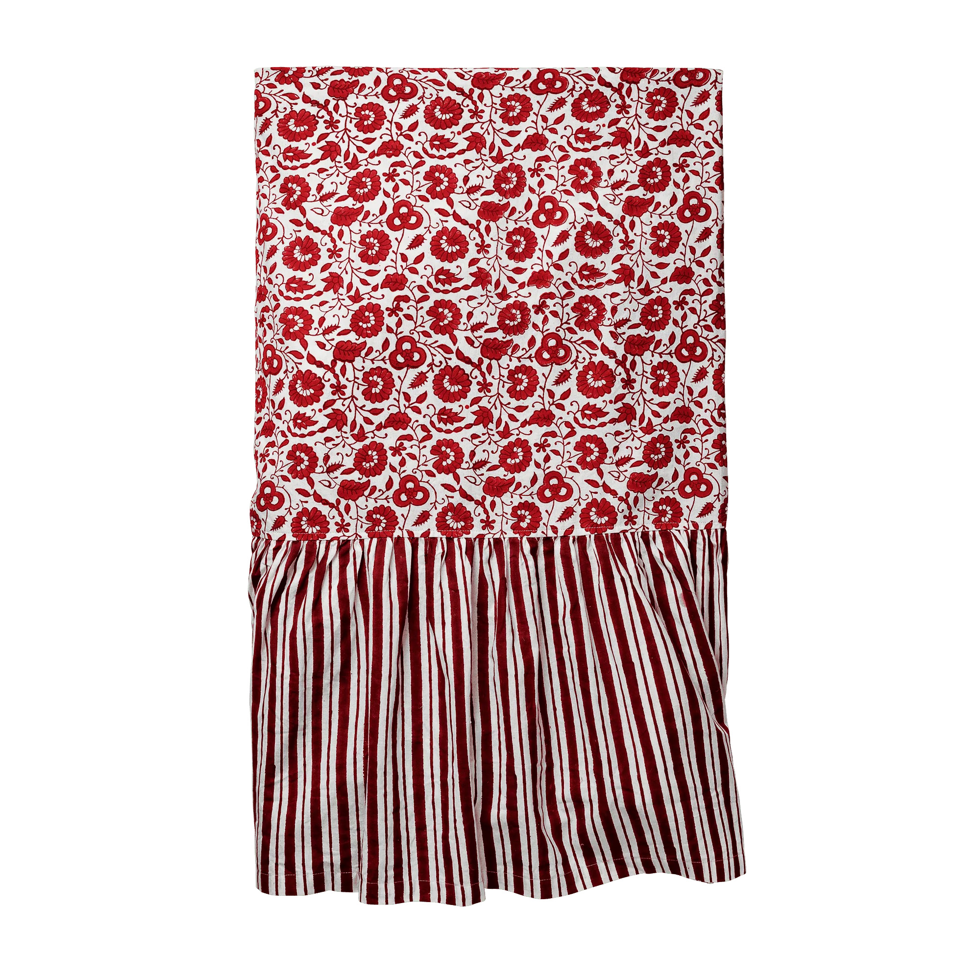 A red and white patterned fabric featuring floral and striped designs, displayed vertically with a ruffled section at the bottom.