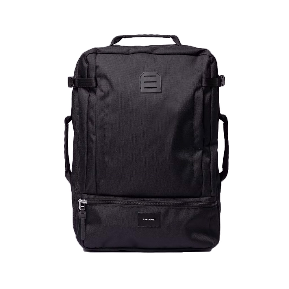 Black backpack with multiple compartments, top handle, and side straps, featuring a small front logo patch.