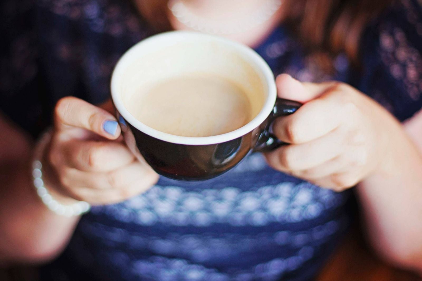 hands offering coffee