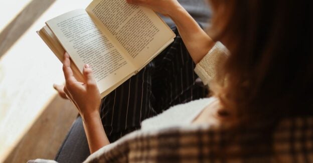 A person relaxing alone with a book