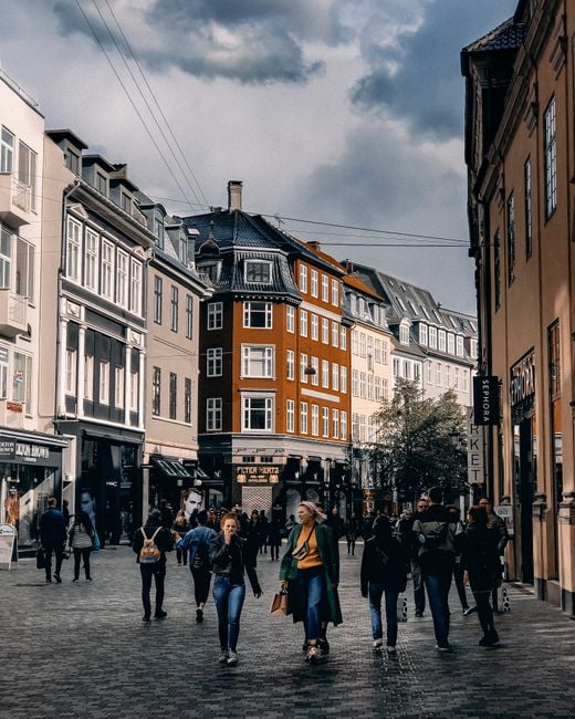 A representative image, not a photograph of any person discussed in the article, showing people walking on a street.