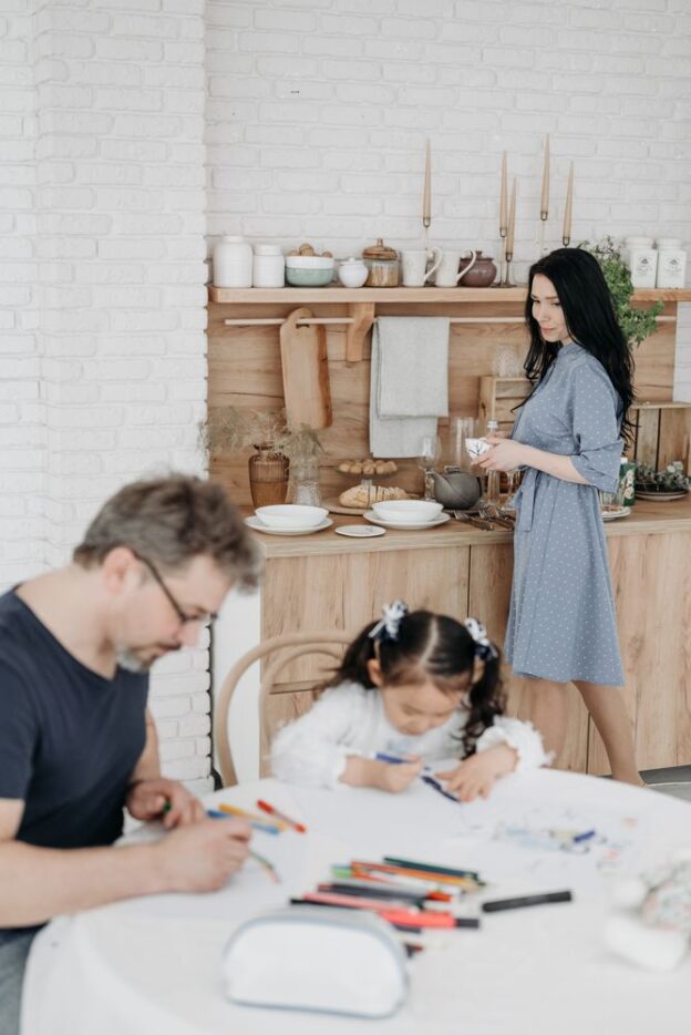 A representative image of a family in a kitchen, not a photograph of any person discussed in the article.