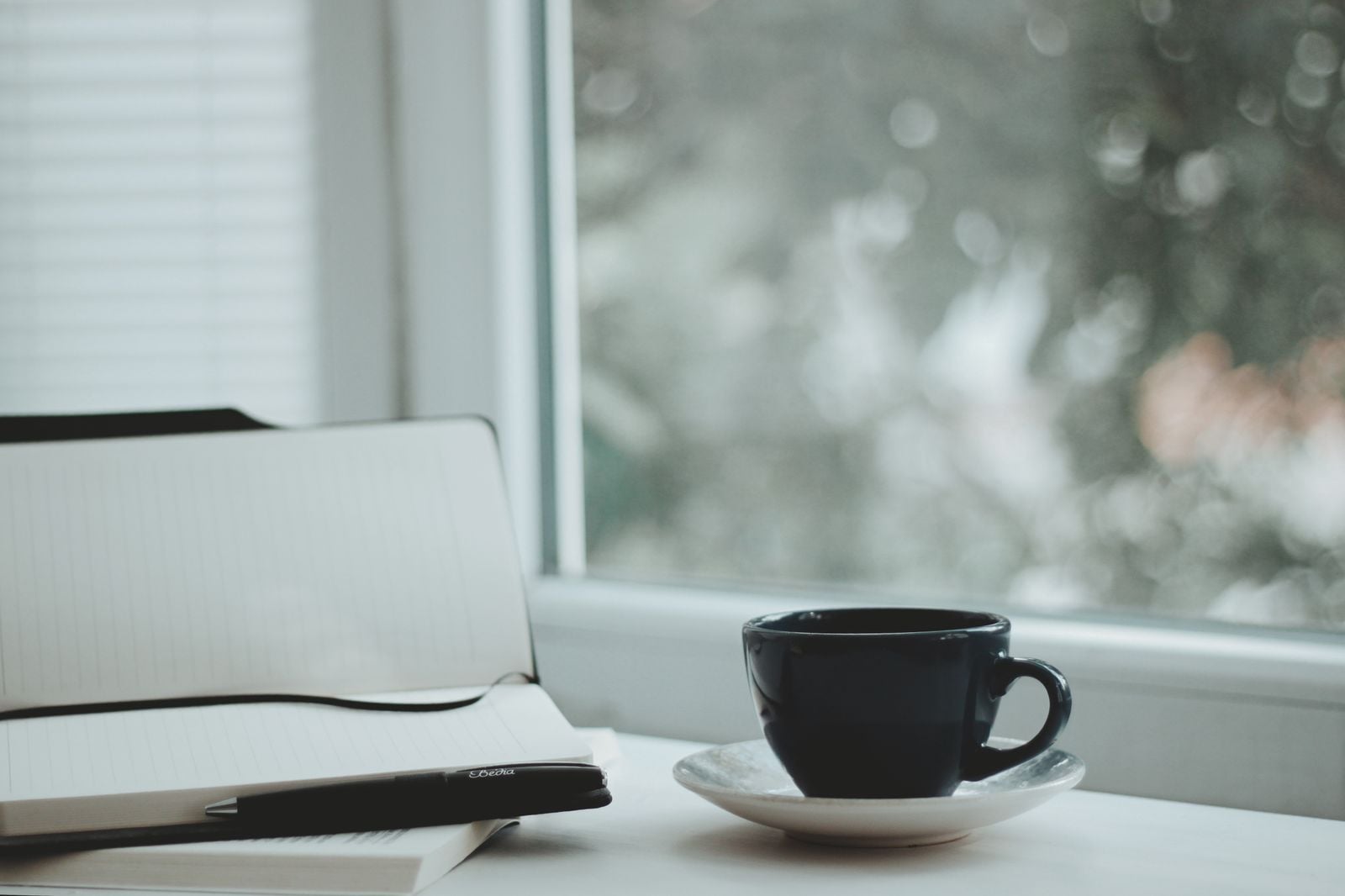 person writing notebook morning
