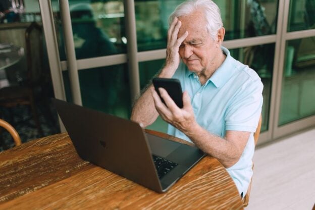 A representative image, not a photograph of any person discussed in the article, showing a senior man having trouble with a laptop.